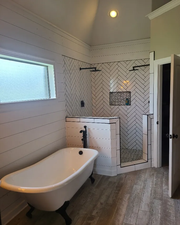 Bathroom remodel with a clawfoot soaking tub, herringbone tile shower and shiplap walls