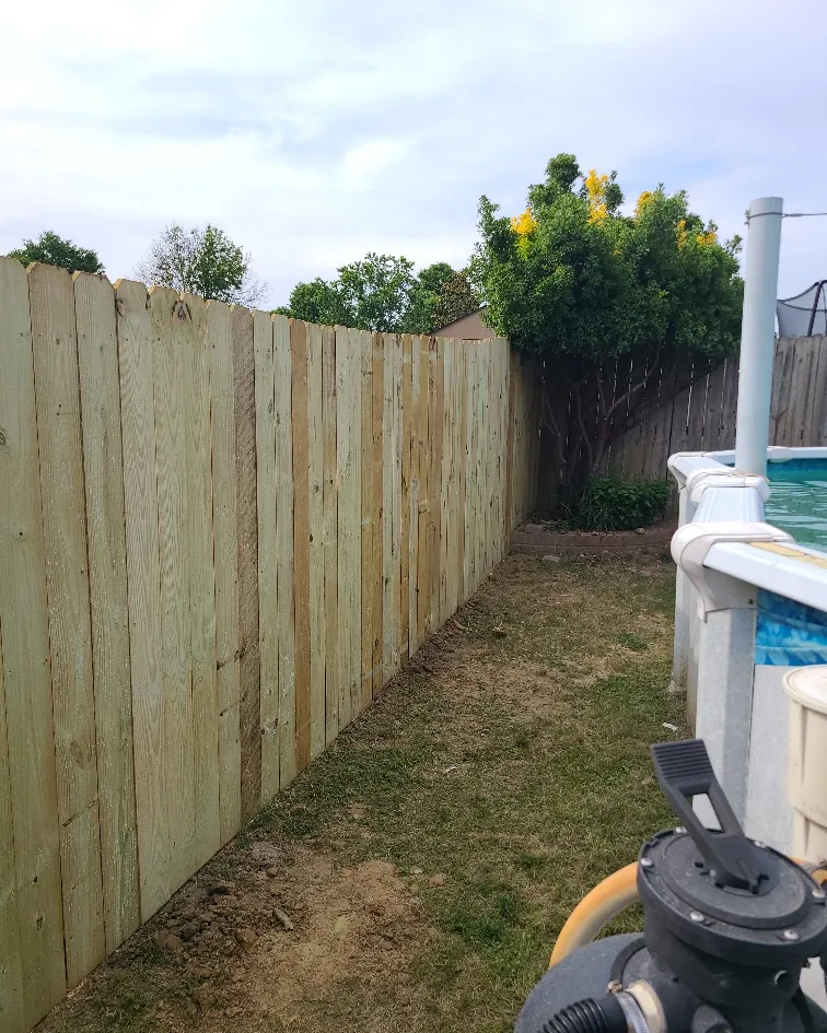 Finished wood privacy fence running the length of a back yard