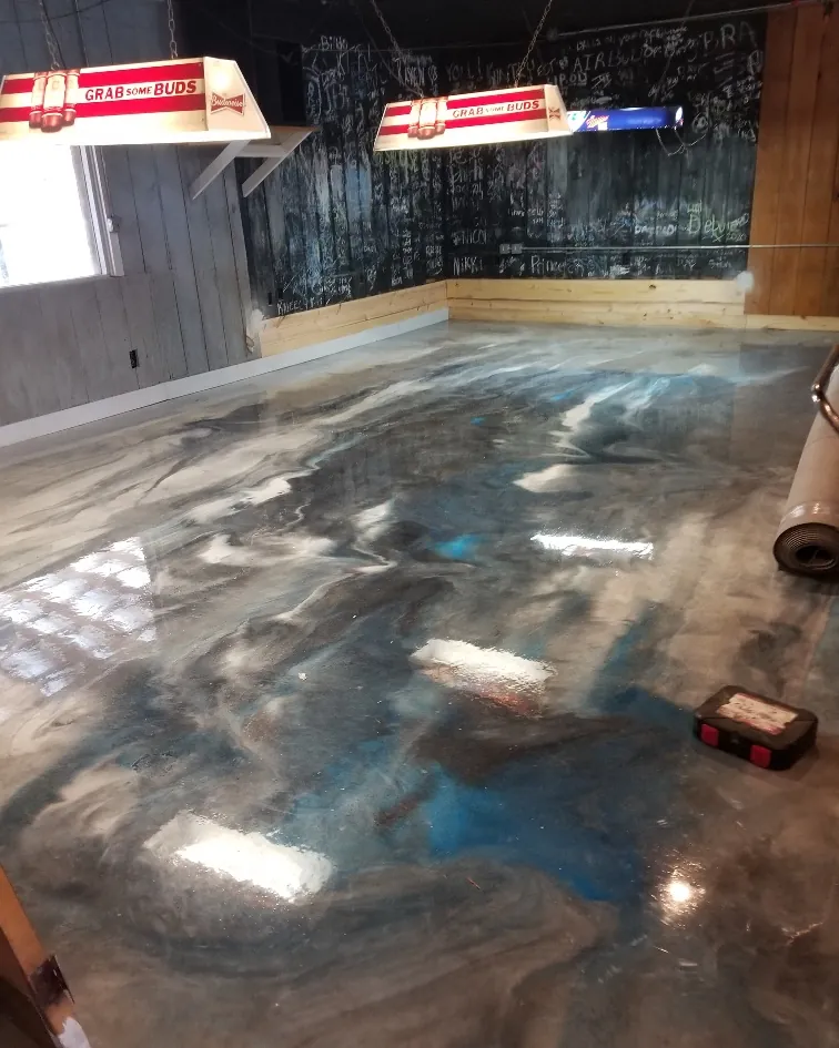 Metallic epoxy floor coating with a blue and pewter marbled finish