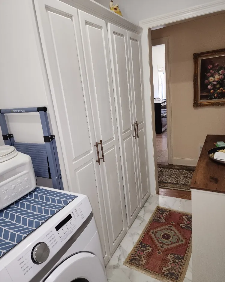 Custom white panel doors built into a laundry and storage area