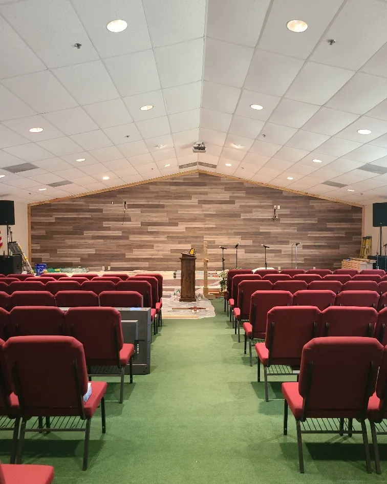 Commercial sanctuary remodel with a stained wood accent wall and new ceiling