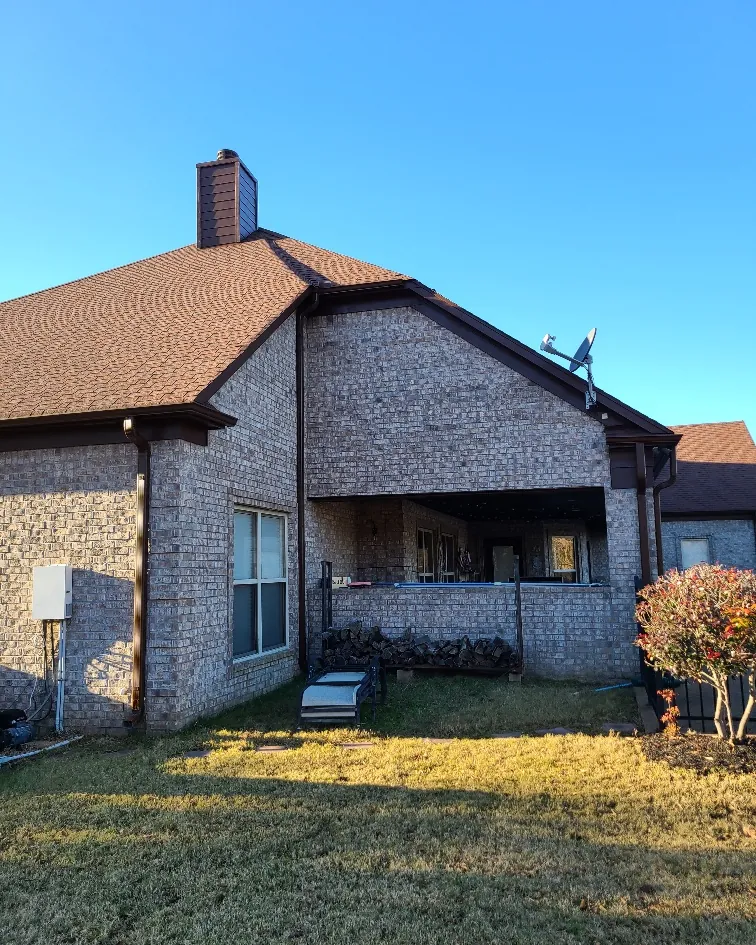 Rear elevation of a brick home with a covered porch area