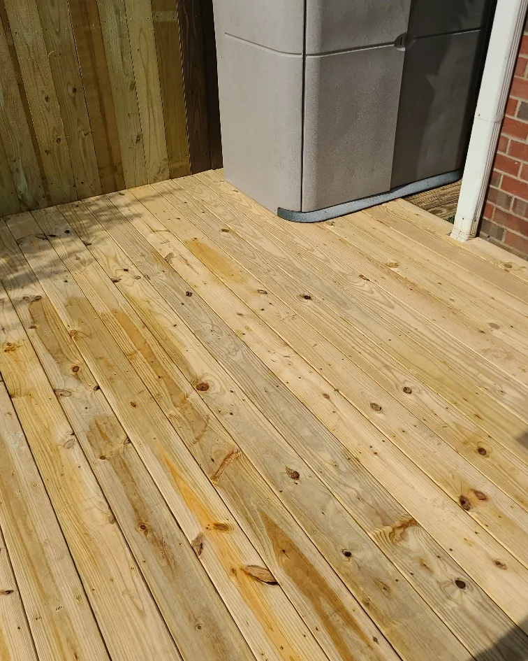 New pressure-treated deck boards installed on a completed deck