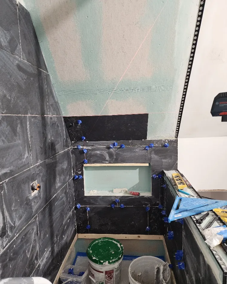 Shower walls stripped back to the studs and re-tiled during a bathroom rebuild