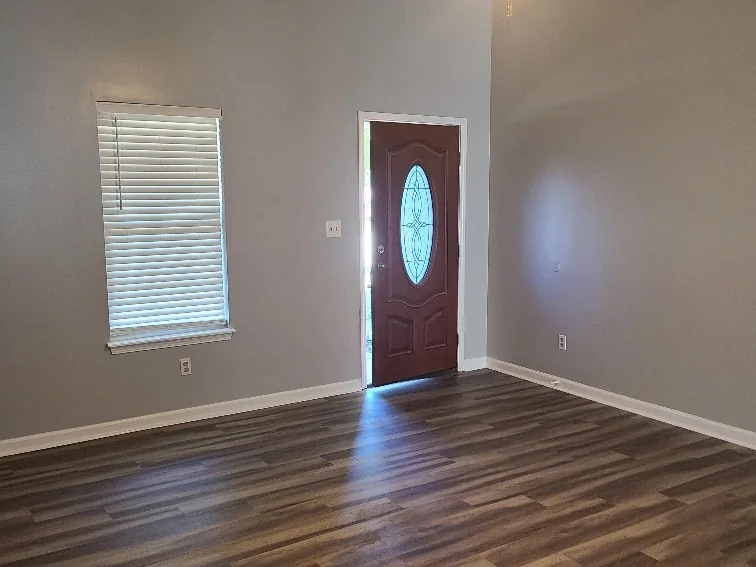 New front entry door with a glass insert and new plank flooring