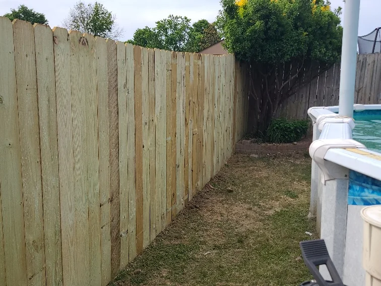 Finished wood privacy fence running the length of a back yard