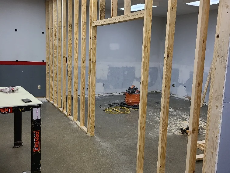 Interior wall framing rebuilt with new studs during a structural repair